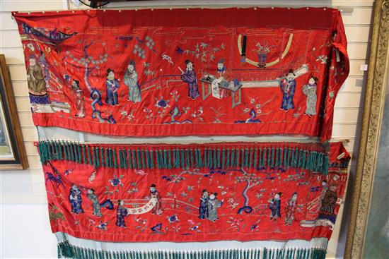 A Chinese embroidered silk red satin panel, early 20th century, approx. 66 x 410cm.